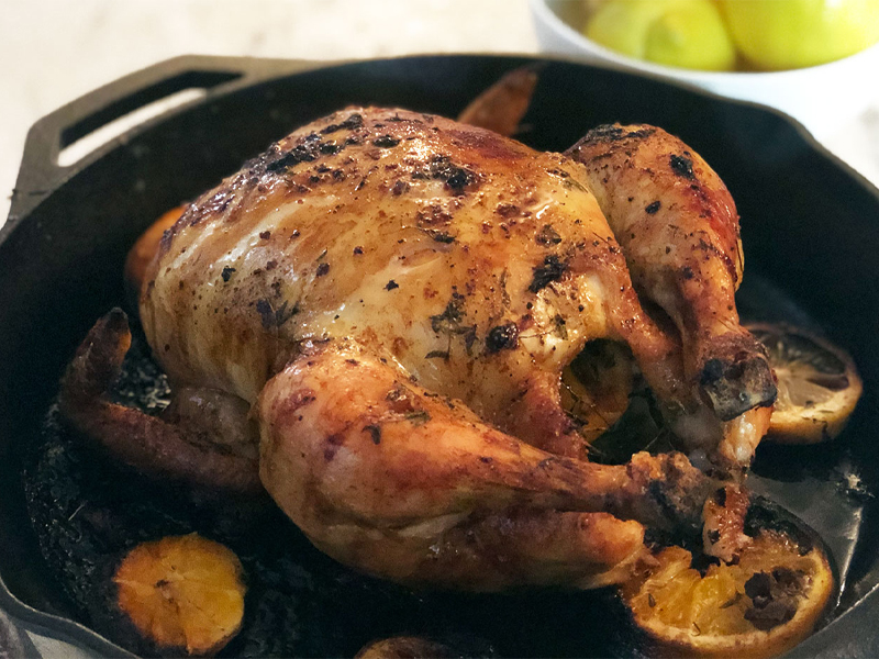 Whole roasted citrus chicken in cast iron skillet
