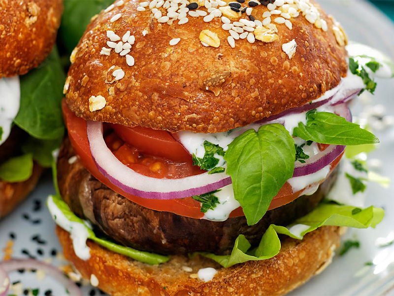 Portobello mushroom "burger" on a bun with lettuce and tomato 