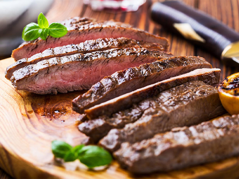 sliced flank steak on a cutting board
